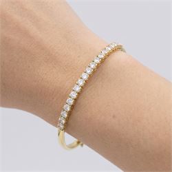 18ct gold diamond bracelet, set with twenty-one graduating round brilliant cut diamonds, to an articulated link bracelet, Birmingham import mark 1981, total diamond weight approx 1.25 carat