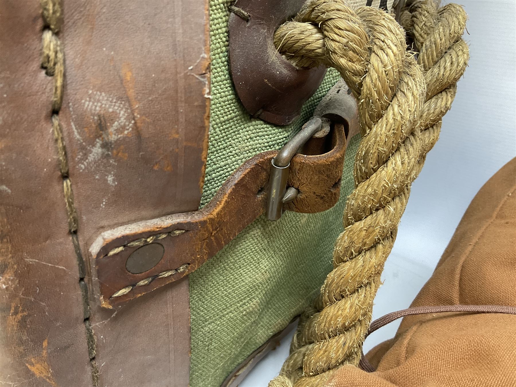 WW2 British Army RAMC 'Regimental Medical Pannier', well marked externally and dated 1941, stamped May 1943 internally, canvas covered wicker form with leather edges, hinged top and fall front with two rope carrying handles, fitted iron locking straps with securing chains; contains various unused field dressings and bandages with WW2 dates and two pillows; original label under lid L79cm