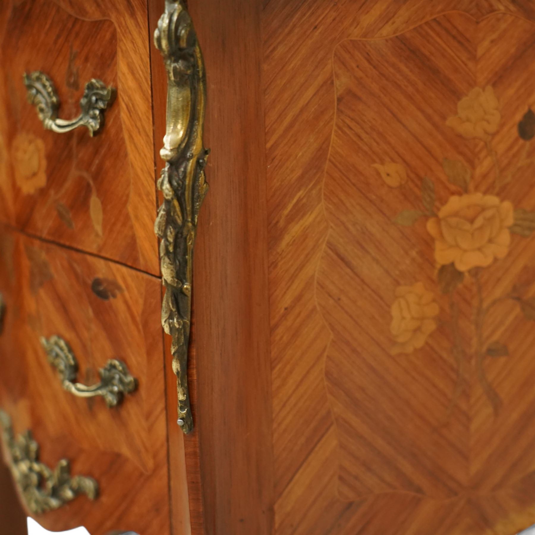 Pair of early 20th century French marquetry bedside cabinets, each serpentine marble top above two drawers with floral inlay, ormolu mounts and handles, on slender cabriole supports with sabots