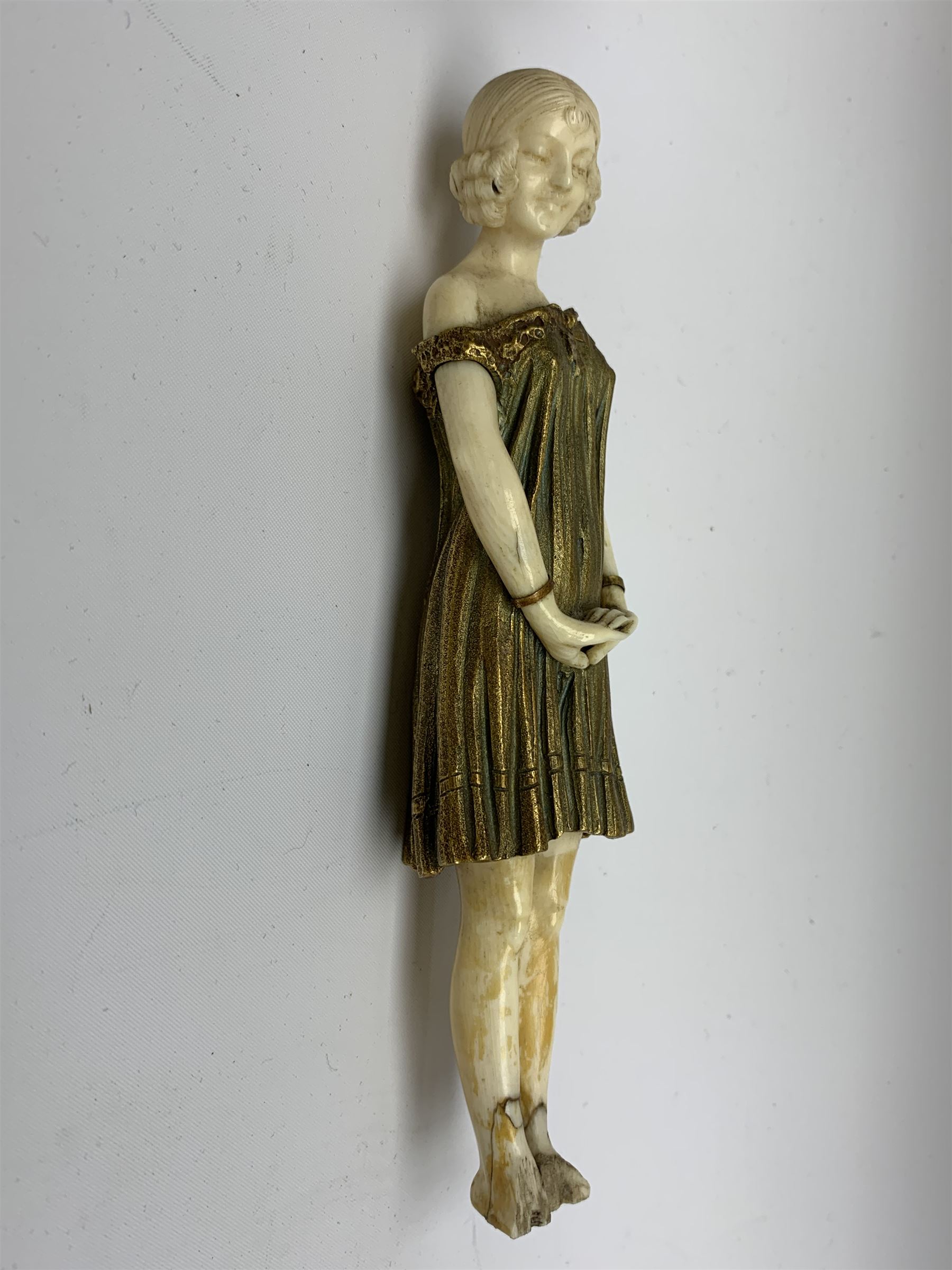Demetre Chiparus (1886-1947): Innocence, a gilt bronze and ivory figure, circa 1925, standing in contemplative post with hands clasped, upon onyx plinth, signed to base, H24.4cm
