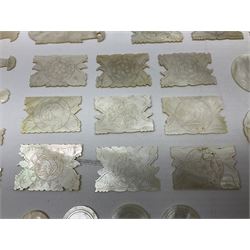 Collection of fifty two Chinese mother of pearl gaming counters or tokens, of various size and form including rectangular, circular and fish shaped examples, various decoration including floral motifs, largest rectangular examples L4cm