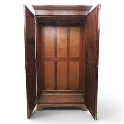 Quality Edwardian mahogany double wardrobe, featuring bevelled mirrored and panelled door with applied moulded detail, internal brass rail hanging and shoe rails