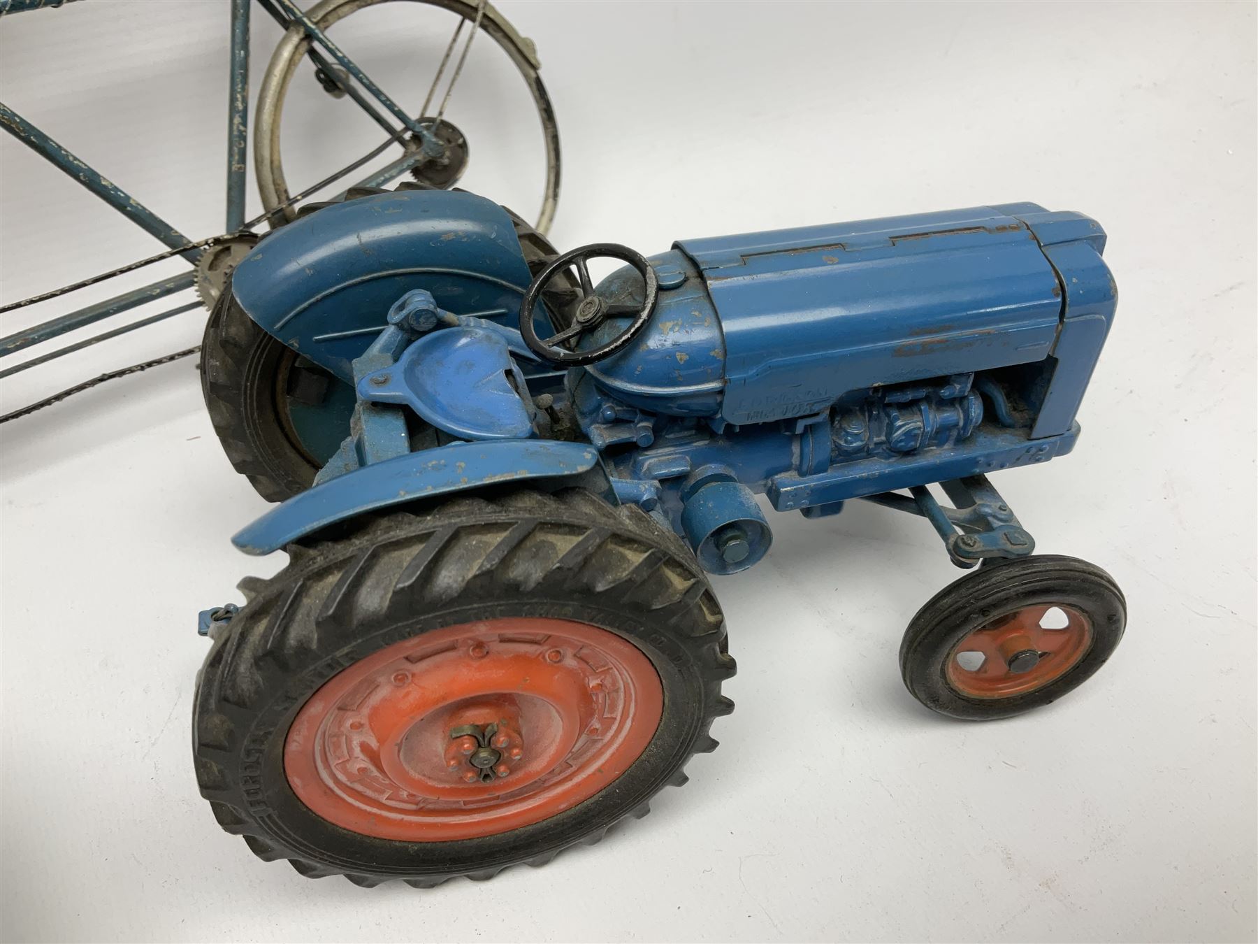 Chad Valley clockwork Fordson Major Tractor, a group of play worn Britains and other lead and metal farm animals, figures and accessories including a kennel, haystacks, dovecote, cows, sheep etc, together with a diecast model of a Tandem Bike L31cm
