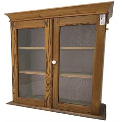 19th century pine cabinet, projecting moulded cornice over two glazed doors, fitted with two shelves