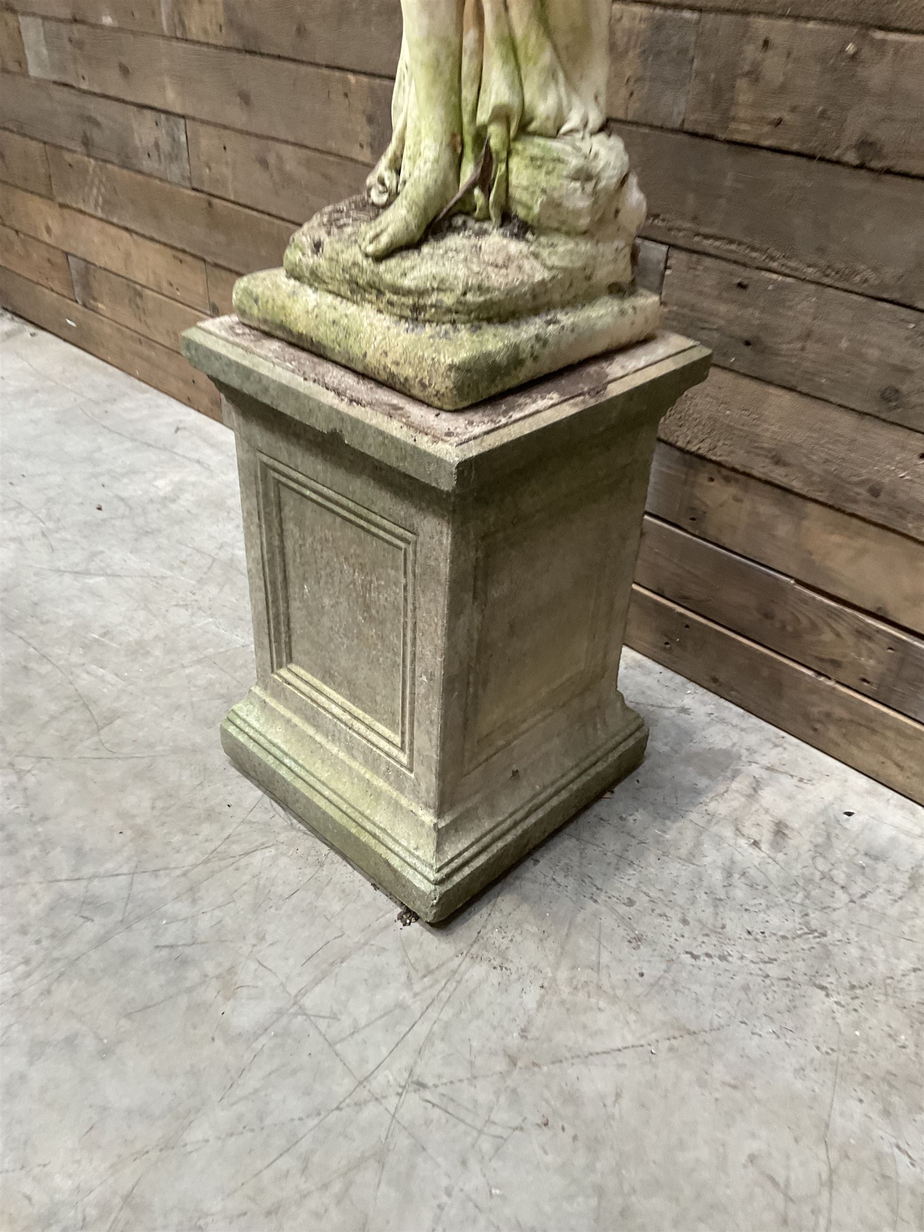 Cast stone garden figure of a bathing lady, raised on square plinth