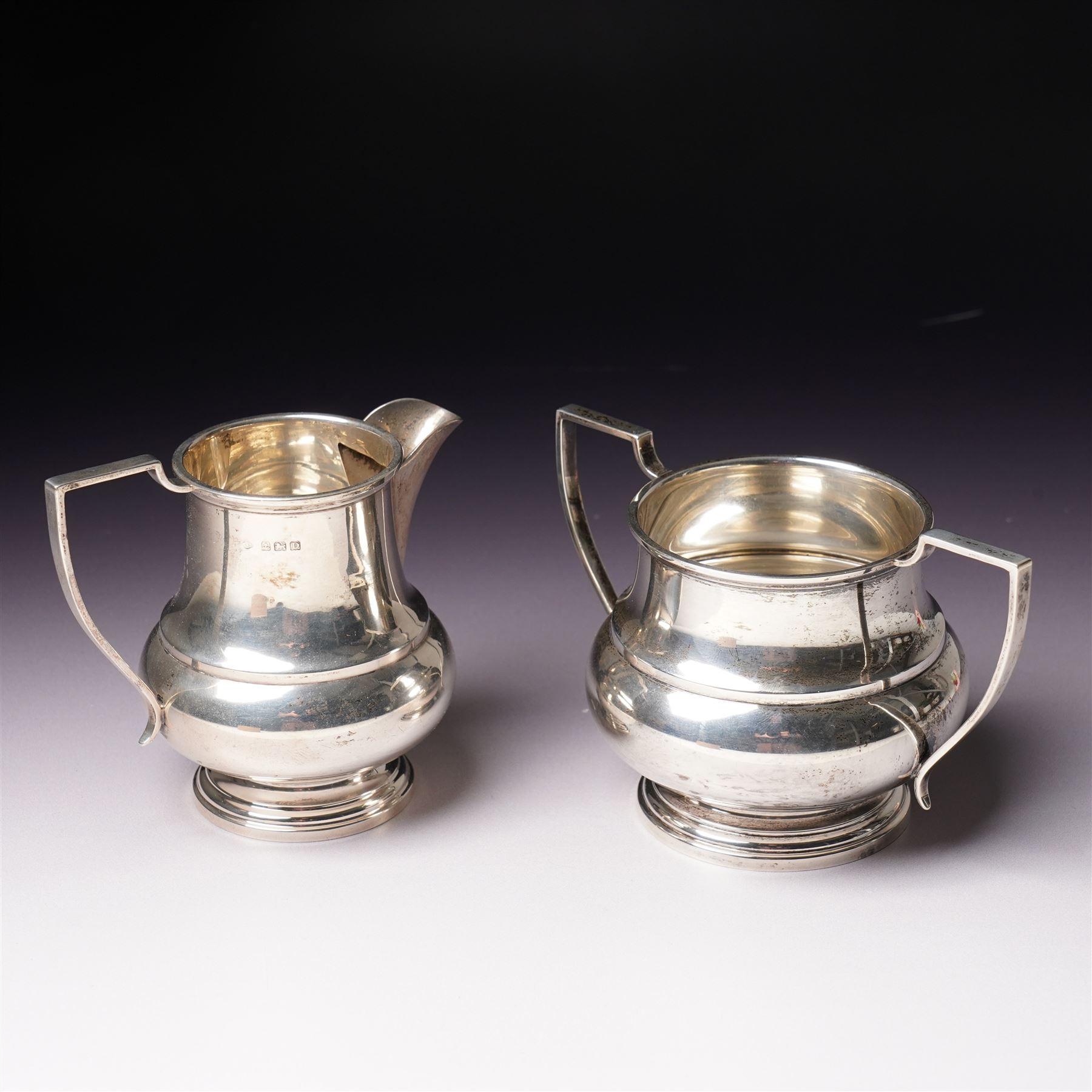 Silver baluster cream jug and matching two handled sugar bowl Birmingham 1928 Maker s mark K & L