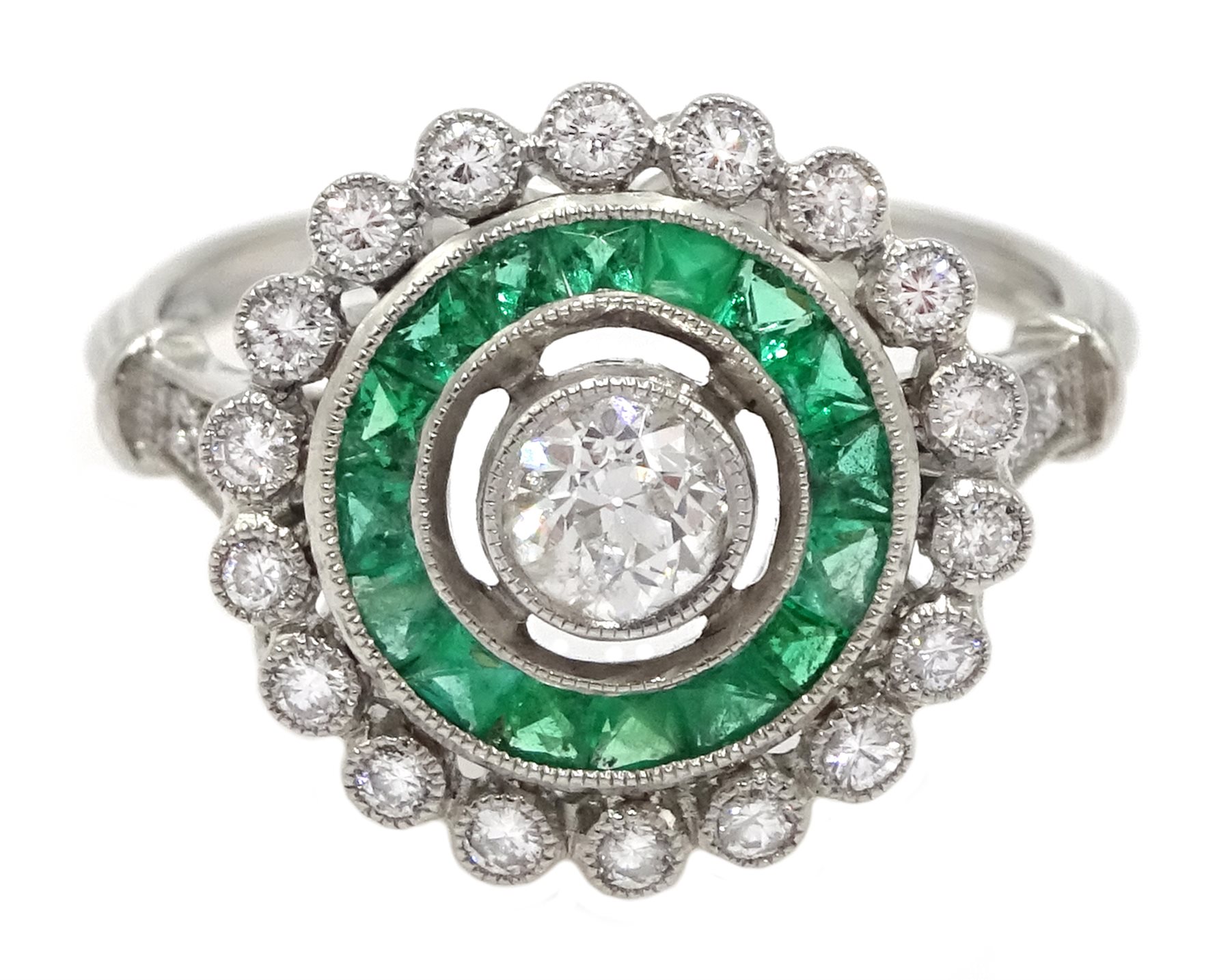 Platinum round diamond and calibre cut emerald target design ring, with diamond set shoulders