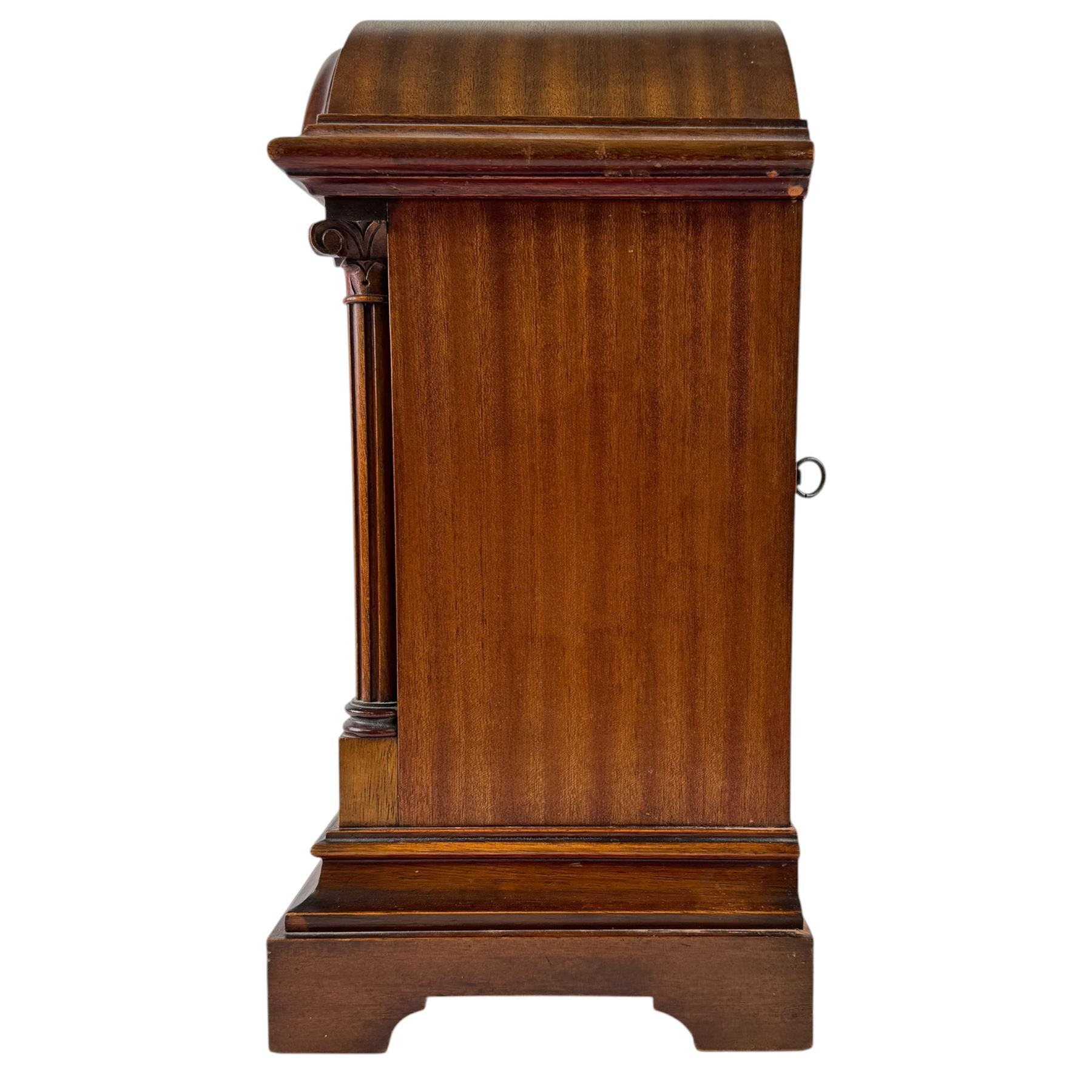 Gustav Becker, German 20th century 8-day mahogany cased mantle clock, break arch mahogany case with a round topped door flanked by reeded pilaster with Ionic capitals and raised on a stepped plinth, the dial with engraved Roman numerals, with steel fleur di Lis hands, and  chime /silent dial, H43cm