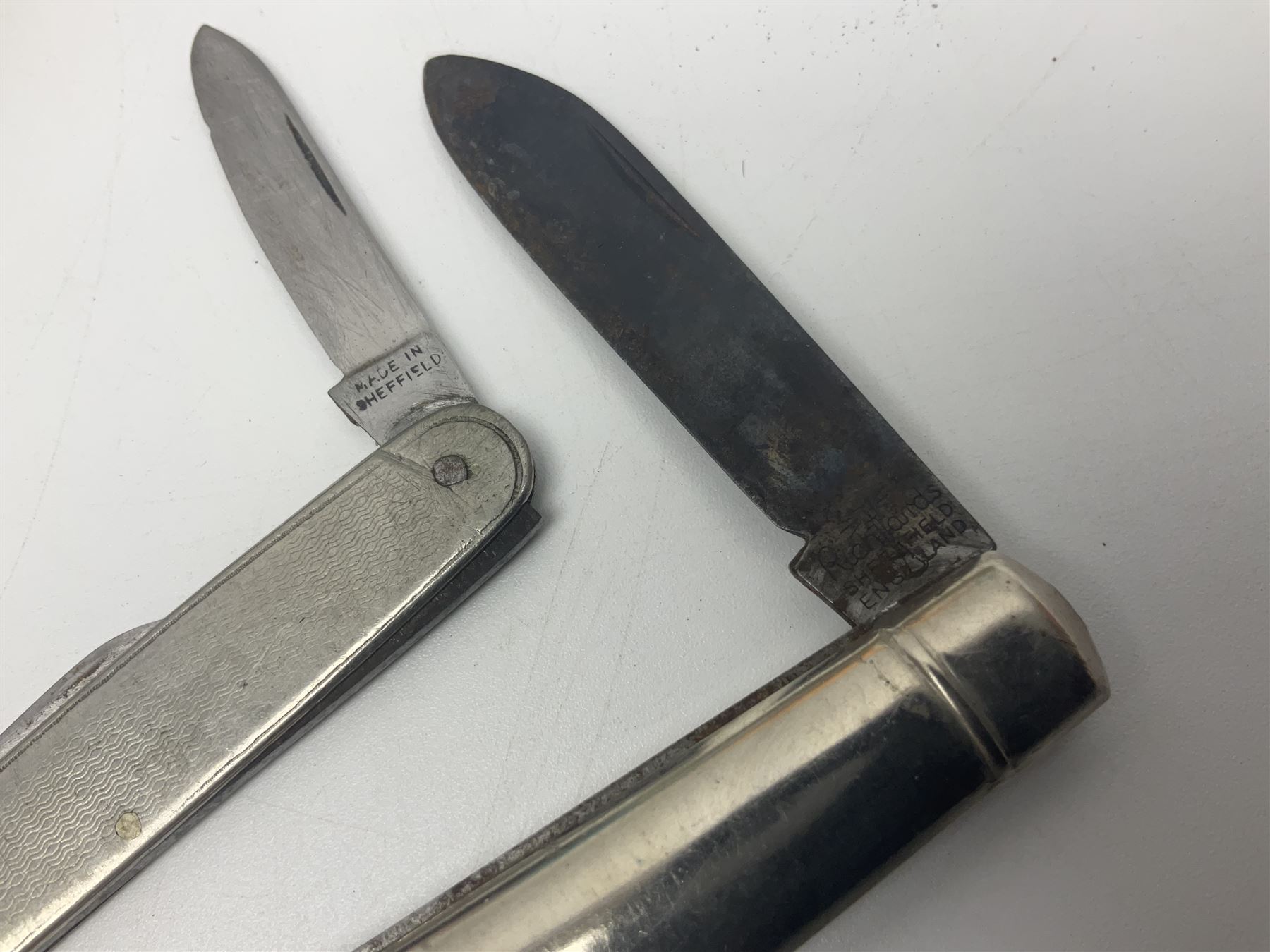 Seven pen knives, two lighters, including one Ronson example and a collection of postcards