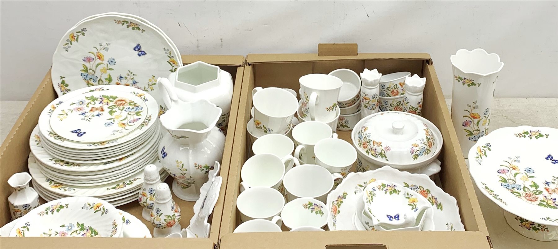 A large quantity of Aynsley Cottage Garden dinner and tea wares, to include dinner plates, dessert plates, side plates, bowls, serving dish, serving dish and cover, ramekins, cruets, mugs, large jug, pair of candle sticks, various vases, pin dishes, etc. 