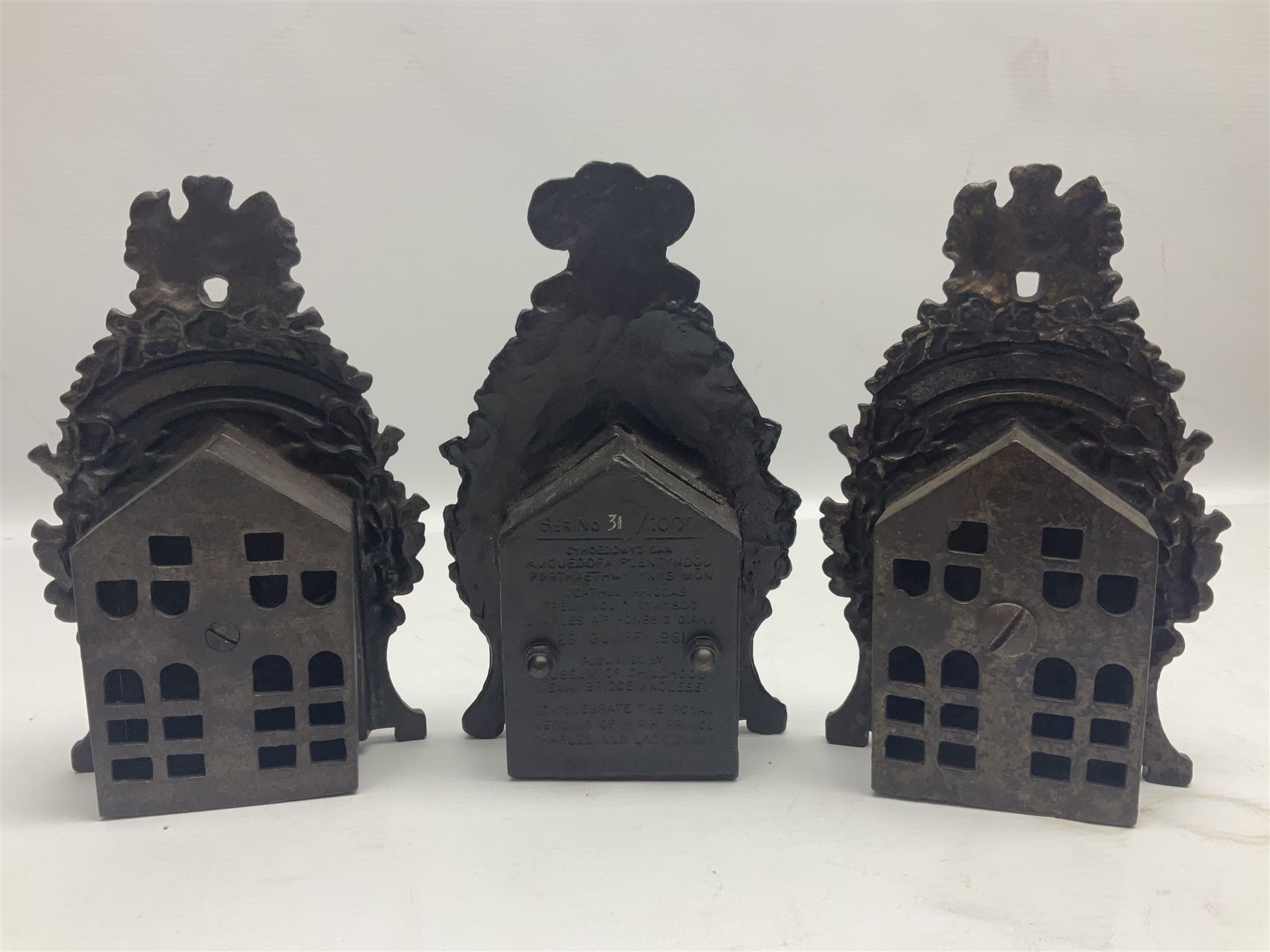 Two early 20th century cast-iron money banks - 'Our Kitchener Bank' c1914 H17cm and 'Our Empire Bank' c1911 depicting George V and Queen Mary H17cm; both by Sydenham & McCoustra; and another similar for The Prince & Princess of Wales 1981 by Robert Brown (3)