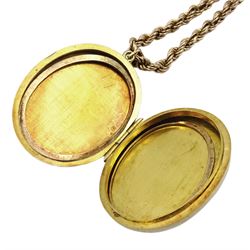 Gold locket pendant with engraved decoration, on gold rope twist necklace, both hallmarked 9ct 