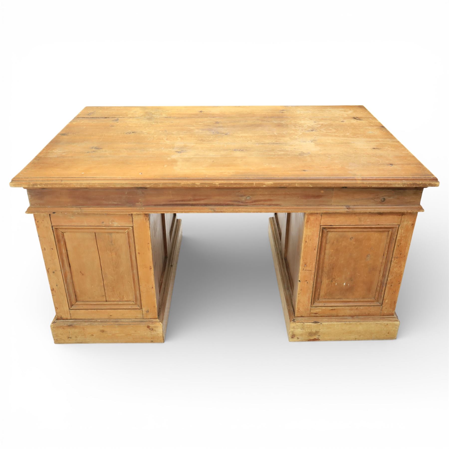 Late 19th century Victorian pine twin pedestal desk, rectangular plank top above an arrangement of seven drawers with brass swan neck handles, each pedestal fitted with one drawer above a double height drawer, raised on plinth bases with panelled sides
