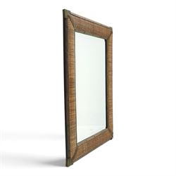Rustic wall mirror with brass, leather and rattan frame, enclosing a bevelled plate