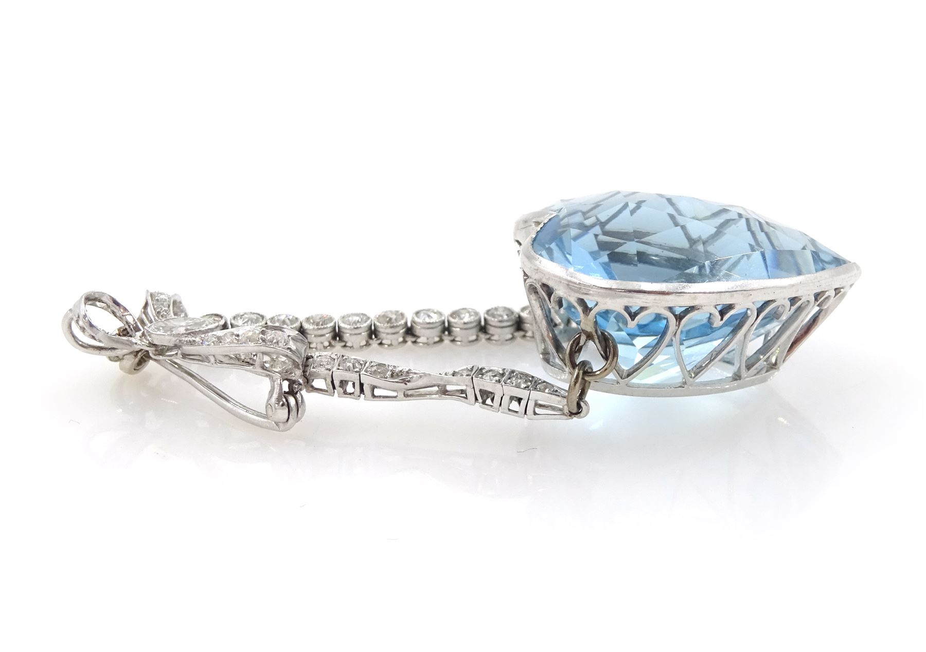 Platinum aquamarine and diamond pendant / brooch, the large faceted heart cut aquamarine, mounted within an openwork heart design gallery, suspending from a polished and milgrain set old cut diamond pendant, with bow design brooch top, set with further old cut diamonds and a single marquise cut diamond, in fitted velvet and silk lined box by Bloom & Sons, London, aquamarine approx 55.00 carat, total diamond weight approx 0.60 carat