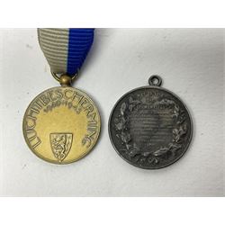 RMS Lusitania iron medallion dated 5th May, 5.5cm diameter, boxed with St Dunstan's Blinded Soldiers Profit paperwork; another unboxed similar Lusitania medallion; 30th Corps Alamein Cuxhaven medallion; Battle of Jutland 1916 silver memorial pendant; Navajo Code Talkers medallion 2000; and five other military related medallions