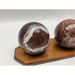 Set of three marble spheres on a elongated octagonal wooden base, H12cm