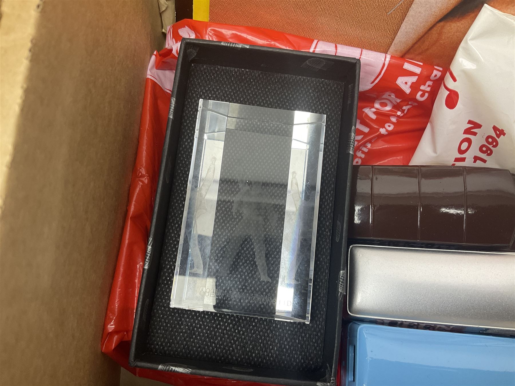 Mostly Queen and Freddie Mercury interest items, including pin badges, newspaper cuttings, diecast 'promotional' vehicles, special edition Pop Rocks figure of Freddie Mercury, VHS tapes, two charity certificates signed by Brian May and Roger Taylor, poster etc, in two boxes 