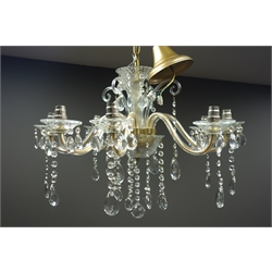  Eight branch clear glass chandelier, cut glass drops, scrolled arms and the branches having faceted decoration  