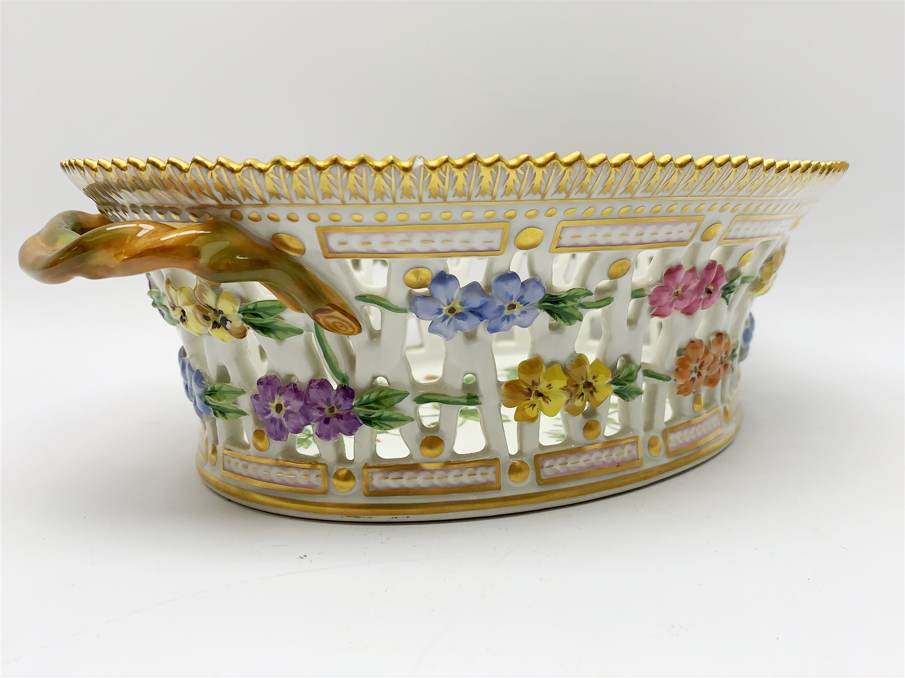 Royal Copenhagen Flora Danica basket, with naturalistically modelled vine handles and reticulated sides detailed with polychrome forget-me-nots, the interior decorated with a botanical study of 'Anagallis arvensis', sprigs and a gilt border, with printed and painted marks beneath, H8cm L26cm 

