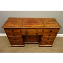  Early 19th century mahogany desk, three sectional figured top with two hinged compartments, centre compartment with dropped baize lined well, above four drawers, two simulated drawers, panelled cupboard and cupboard enclosed by bank of simulated drawers, plinth base, turned ebony handles, possibly Gillows, W137cm, H80cm, D52cm  