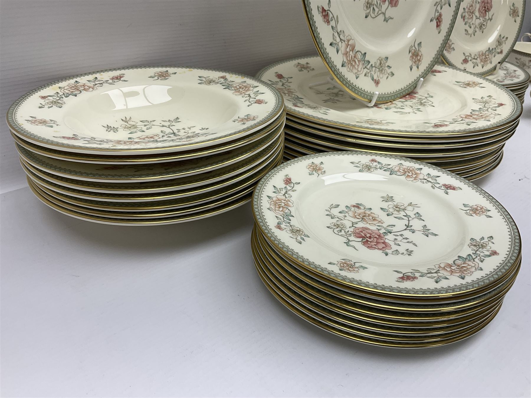 Minton Jasmine pattern tea and dinner wares, including dinner plates, sauce boats, side plates, bowls, teacups, coffee cans and twin handled soup bowls, etc (122)