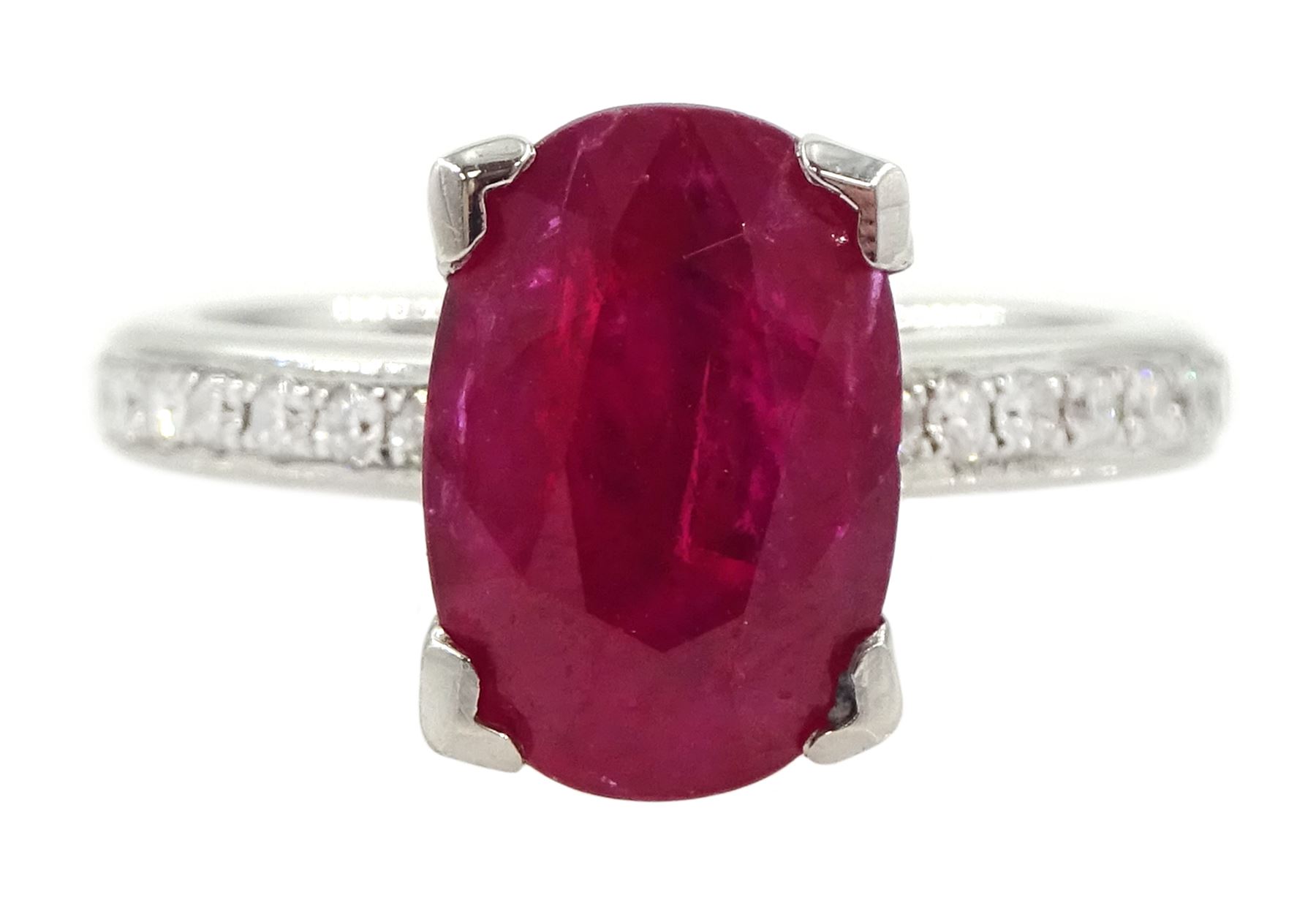 18ct white gold ruby and diamond ring, single oval cut ruby of approx 2.75 carat, with channel set diamond shoulders, hallmarked