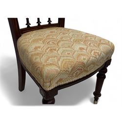 Victorian mahogany centre table, circular top above turned pedestal, terminating on three cabriole legs with scroll feet on porcelain castors, and six scroll carved upholstered dining chairs, with cushion and spindle turned backs, centre table  118x74cm, dining chairs 89x46x50cm