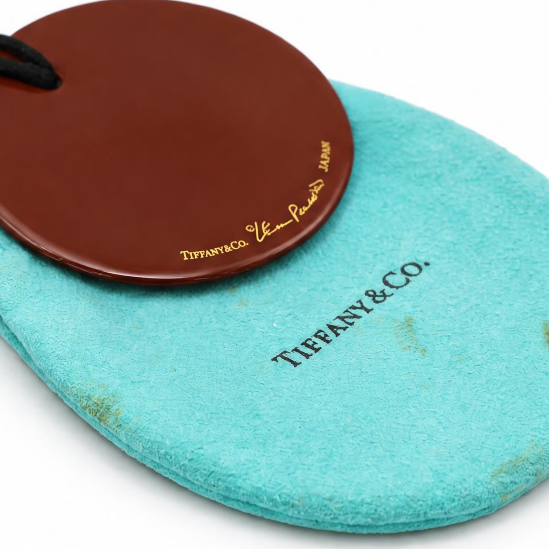 Tiffany & Co. red lacquer on Japanese hardwood round pendant necklace, on black silk cord by Elsa Peretti, signed 