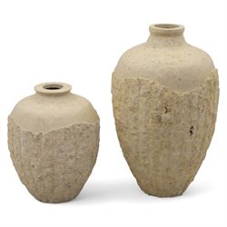 Two Mactan composite stone vases, of rounded tapering form with textured lower bodies and ...