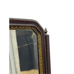 George III mahogany toilet mirror, the rectangular moulded frame with foliate carved and gilt inner slip enclosing bevelled plate, on tapered moulded horns with acorn cast metal finials, the congé moulded base fitted with three drawers, brass ring handles and shaped brass plate escutcheon, upon bracket feet 