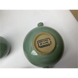 Denby Manor Green pattern dinner ware, including five casserole dishes with lids, butter dish and lid, storage jar with lid, seventeen egg cups,  nineteen soup bowls with twin handles,  three salt pots and two pepper pots, four oval roasting dishes, three pie dishes, three mustard pots with lids, two vinegar pots, eight serving dishes of various shapes and sizes, four bowls, six dinner plates and twelve side plates. 