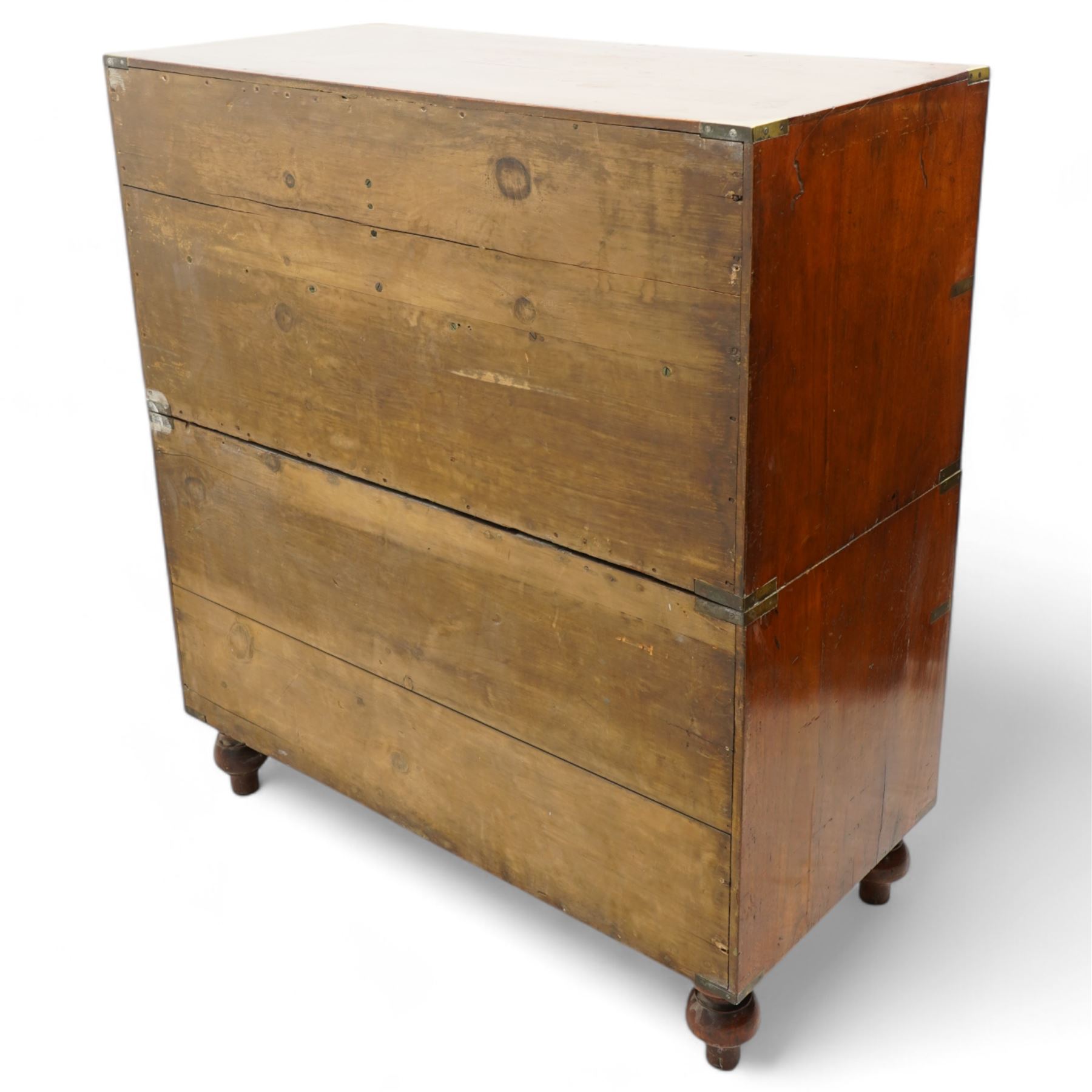 Early 19th century and later teak military campaign chest, mounted and bound with brass strapping and corner brackets, fitted with one deep, two shallow and three long drawers, each with recessed brass handles and shaped escutcheons, on turned feet 