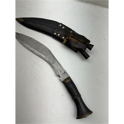 British Service issued Kukri, circa 1980s, with curving blade, hardwood and brass grip in leather covered scabbard with two skinning knives, blade, stamped 12th  December 1980 Dharan Nepal to blade, blade L28cm, overall L39cm