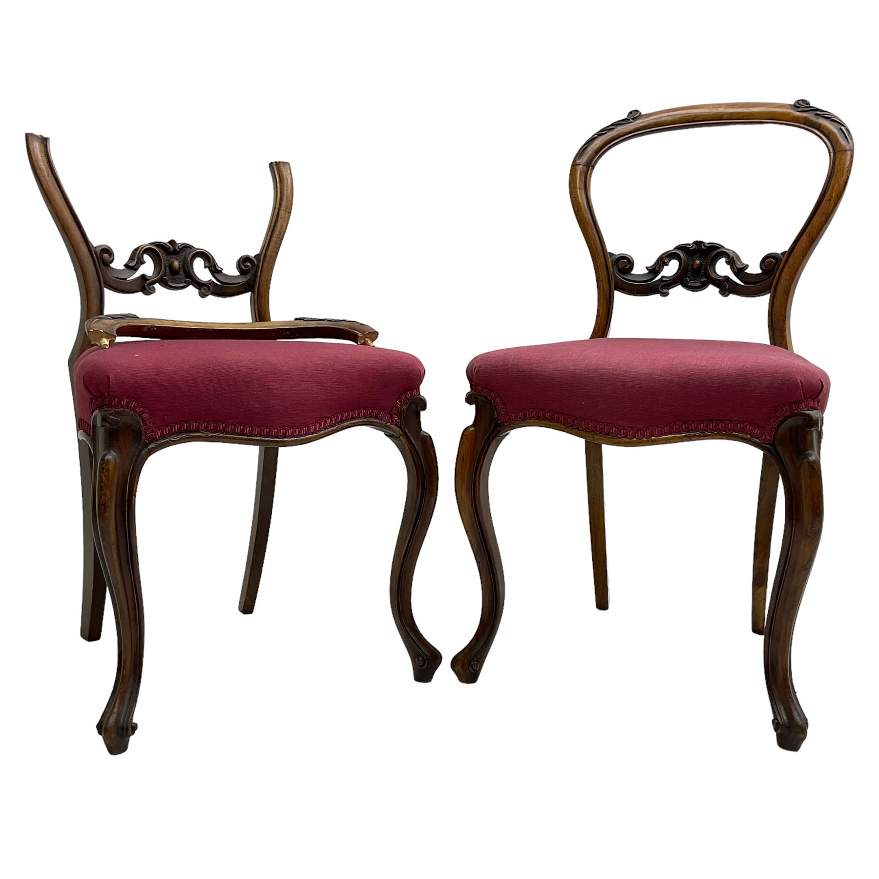 Set of six Victorian rosewood dining chairs, the balloon back carved with foliage scrolls, cartouche carved middle rail with extending scrolls, the seats upholstered in pink fabric, on carved cabriole supports with scrolled terminals 
