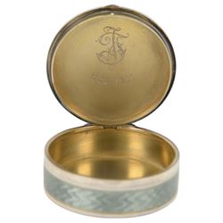 Early 20th century silver and guilloche enamel trinket box, of circular form, decorated throughout with pale green guilloche enamel and a floral wreath to the hinged cover, opening to reveal a gilt interior with personal engraving, import marks for Erich Kellerman, London 1909, D6cm