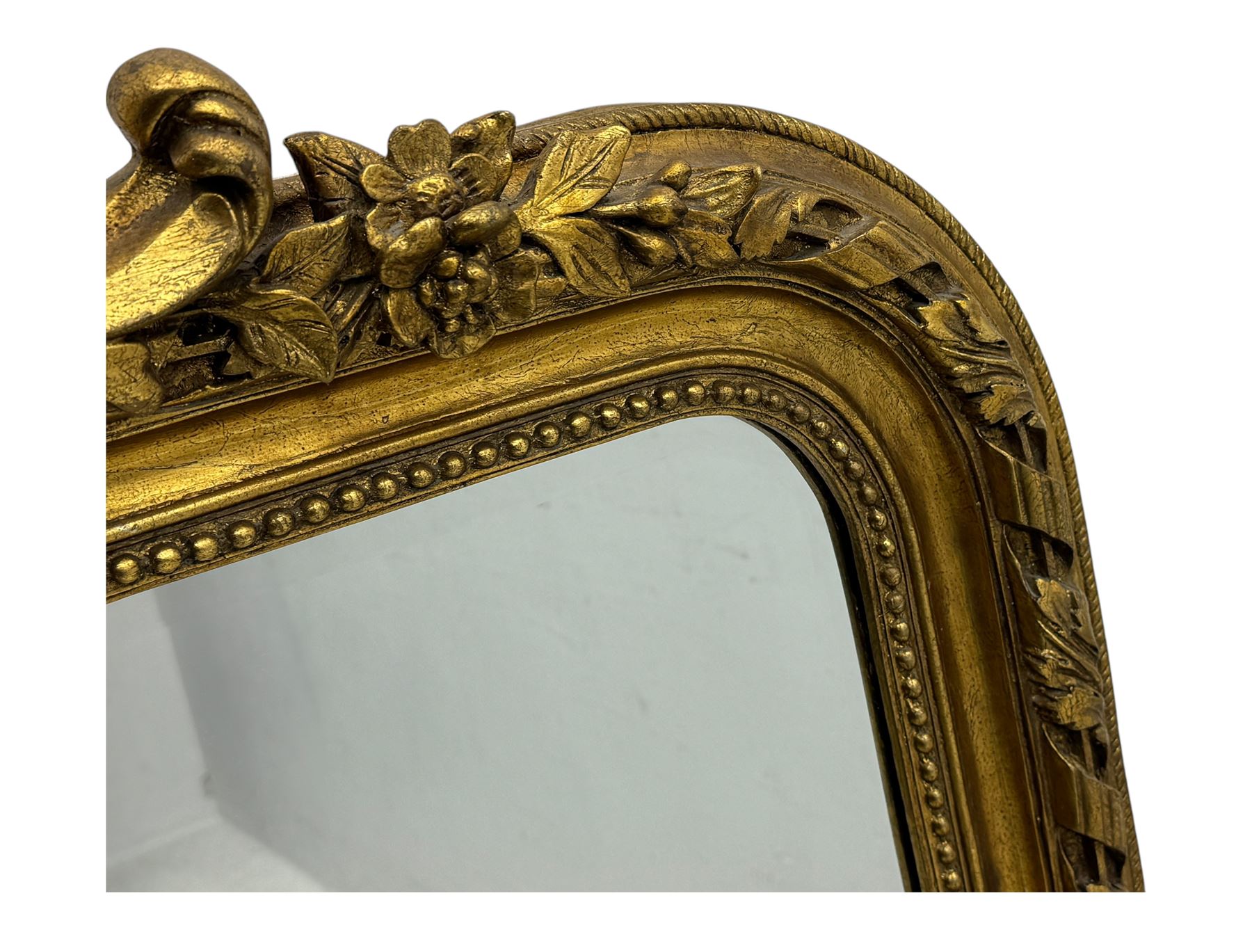 18th century design ornate gilt framed overmantle mirror, bevelled mirror plate within arched frame with pierced pediment featuring foliate and scrollwork designs
