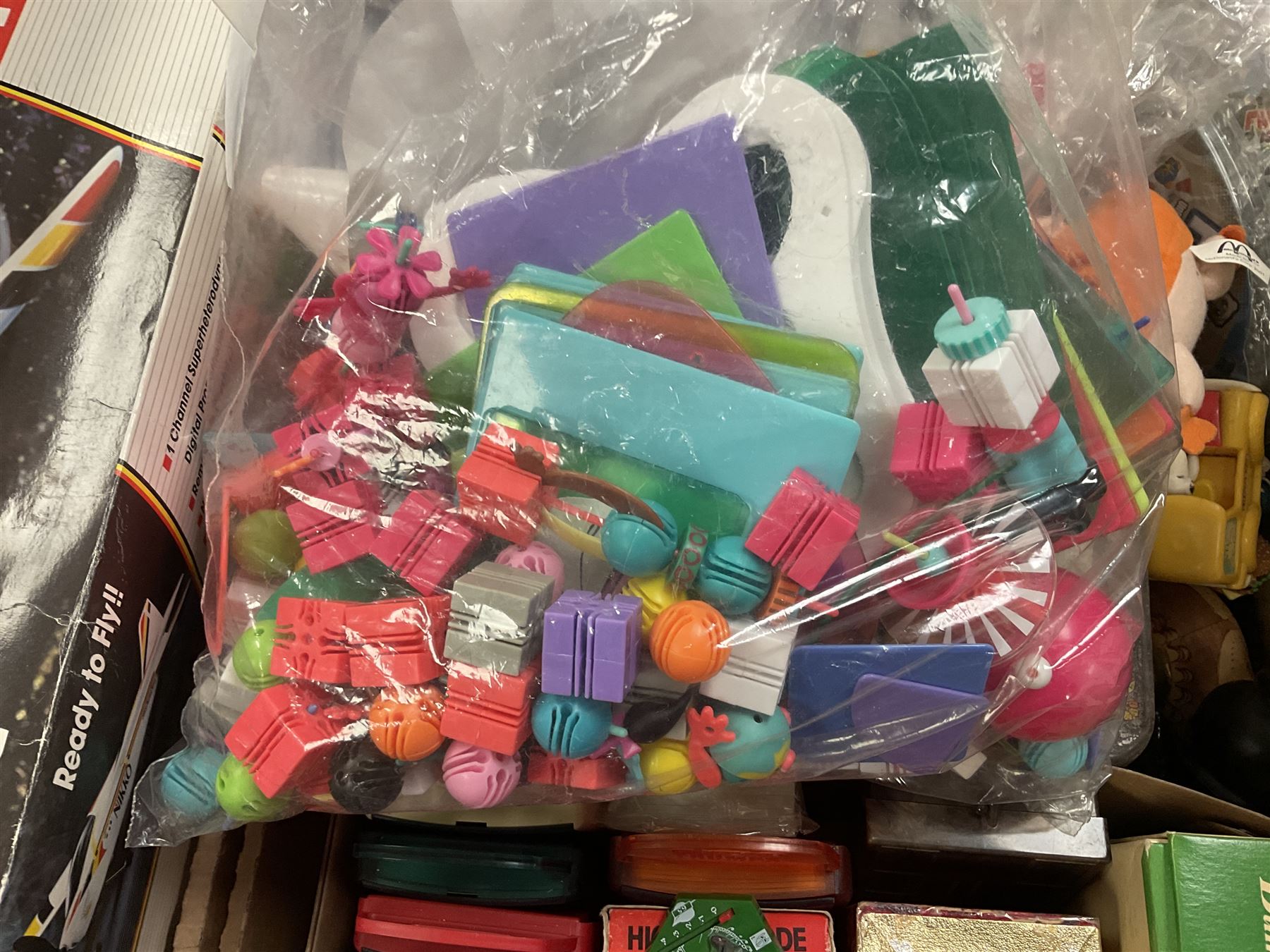 Large quantity of modern toys to include Matchbox Chopper Chase, Nikko battery control airplane, small amounts of K’nex, Meccano, playing cards to include Yu-Gi-Oh cards, keyrings etc in three boxes 