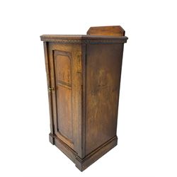 Late Victorian Aesthetic Movement walnut bedside cabinet, enclosed by single panelled door, with floral and geometric inlays