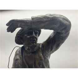 Early 20th century spelter effect figure of a sailor standing in the bow of a boat scanning the horizon, on a simulated rock base with a plaque entitled 'Rescue', base fitted with a timepiece clock movement and two-part dial, with pierced hands, gilt dial centre and ivorene chapter ring written in Arabic numerals, German HAC spring driven going barrel movement wound from the front; with pendulum H65.5cm
