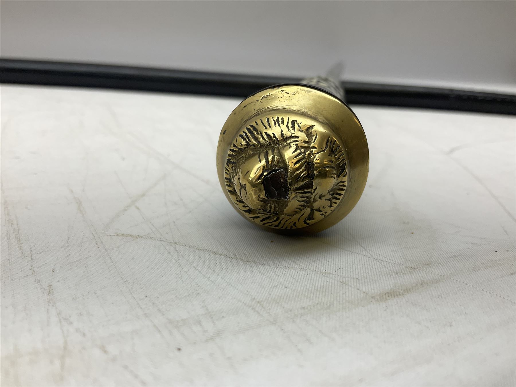 Late 19th/early 20th century Anglo Indian ebony and bone sword stick with 62cm steel blade, brass locking ferrule and lion mask pommel L92 cm.