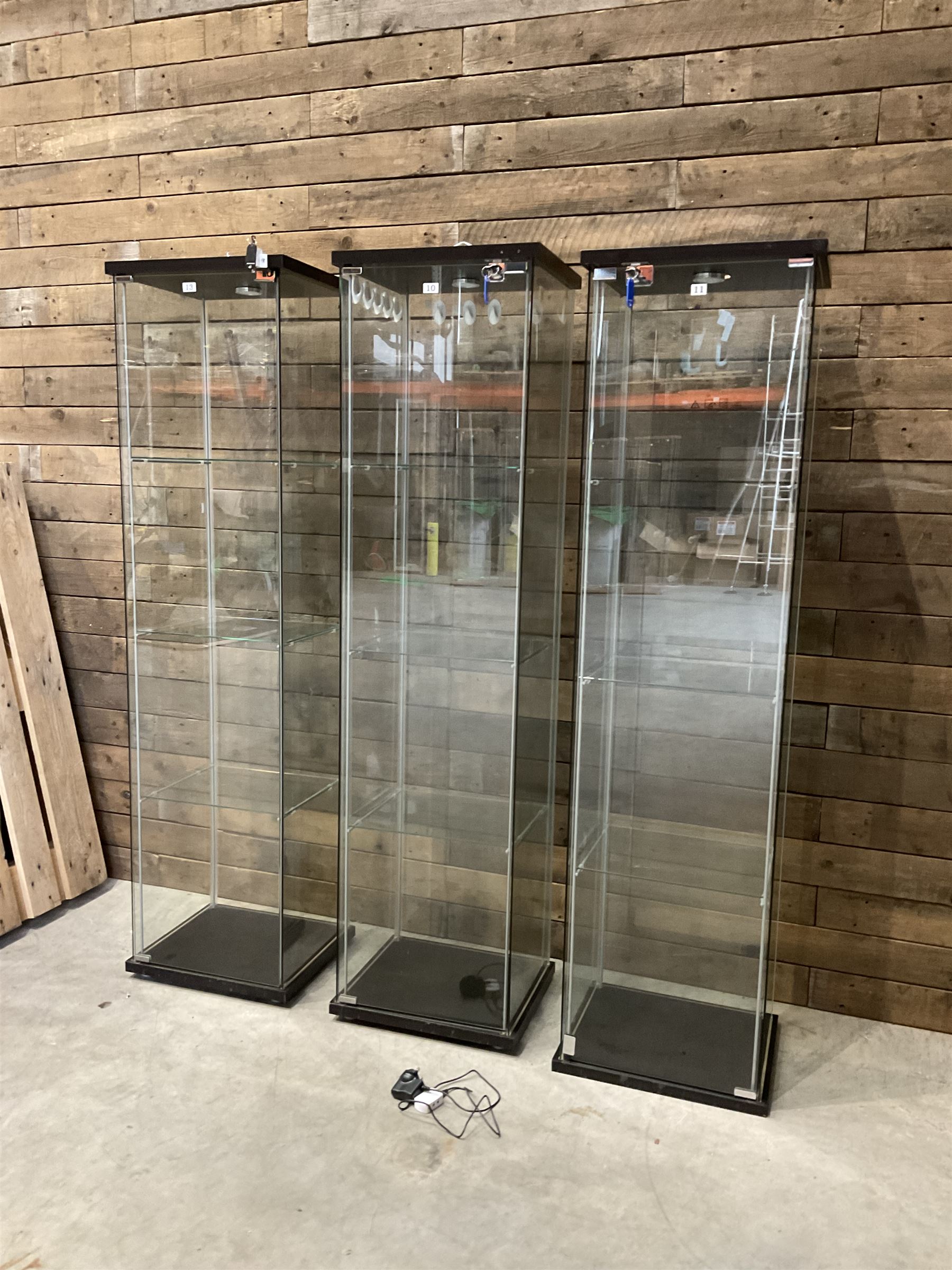 Three Ikea rosewood finish illuminated four glass shop display cabinets, with shelves and keys