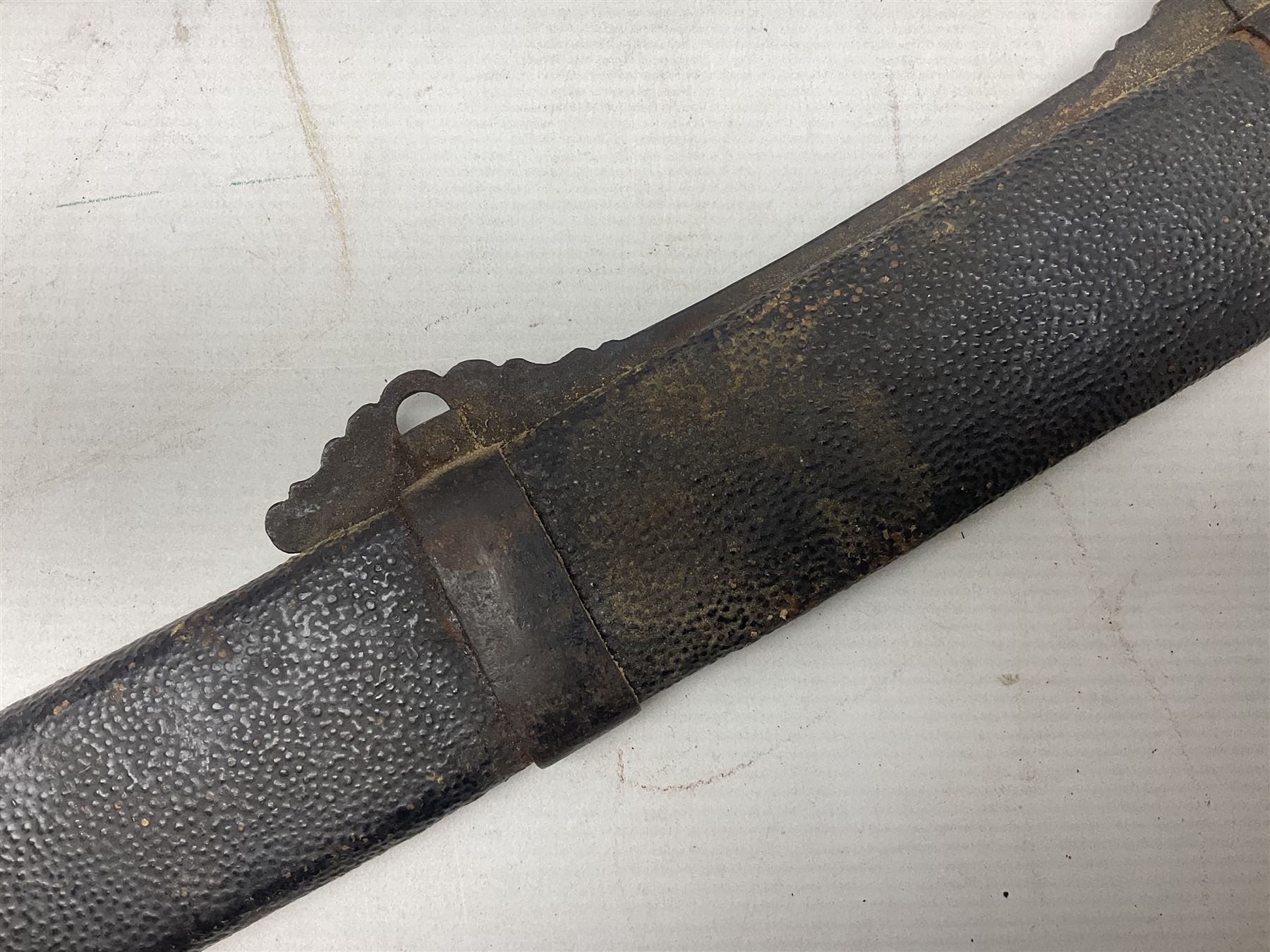 Chinese Boxer Rebellion Period Sword, 69.5cm heavy curved single edge blade with single narrow fuller, plain iron dished circular guard, iron pommel and ferrule with plaited cord bound grip; in skin covered wooden scabbard with iron chape and long suspension mount L95cm overall