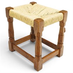Mouseman - mid-20th century oak stool, the rectangular rush seat raised on turned octagonal supports united by box stretcher, with carved mouse signature, by the workshop of Robert Thompson of Kilburn