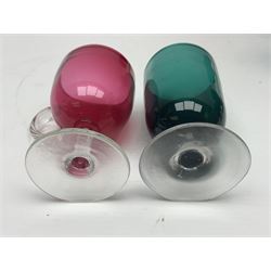 Collection of 19th century coloured glasses, to include nine cranberry glass punch cups, each with clear glass handle and foot and a set of six green glasses, with short clear stems, tallest H10cm