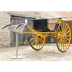 Victorian Two Wheeled Pleasure Driving Round Back Gig by Shanks of London

A Victorian two wheeled pleasure driving round back gig, painted in black and yellow, with upholstered forward facing seat for two, panelled dashboard, wooden spoked wheels, iron step and shafts for a single horse. The vehicle is fitted with a rear luggage compartment and mounted on elliptic springs.

Features
• Black and yellow painted body
• Upholstered forward facing seat
• Panelled dashboard
• Rear luggage compartment
• Wooden spoked wheels
• Iron step
• Elliptic spring suspension
• Shafts for a single horse

Dimensions:
Overall length: 310 cm
Width: 160 cm
Body width: 82 cm
Height: 160 cm

Wheel Diameters:
Wheels: 138 cm

Seating:
Driver and passenger: 2