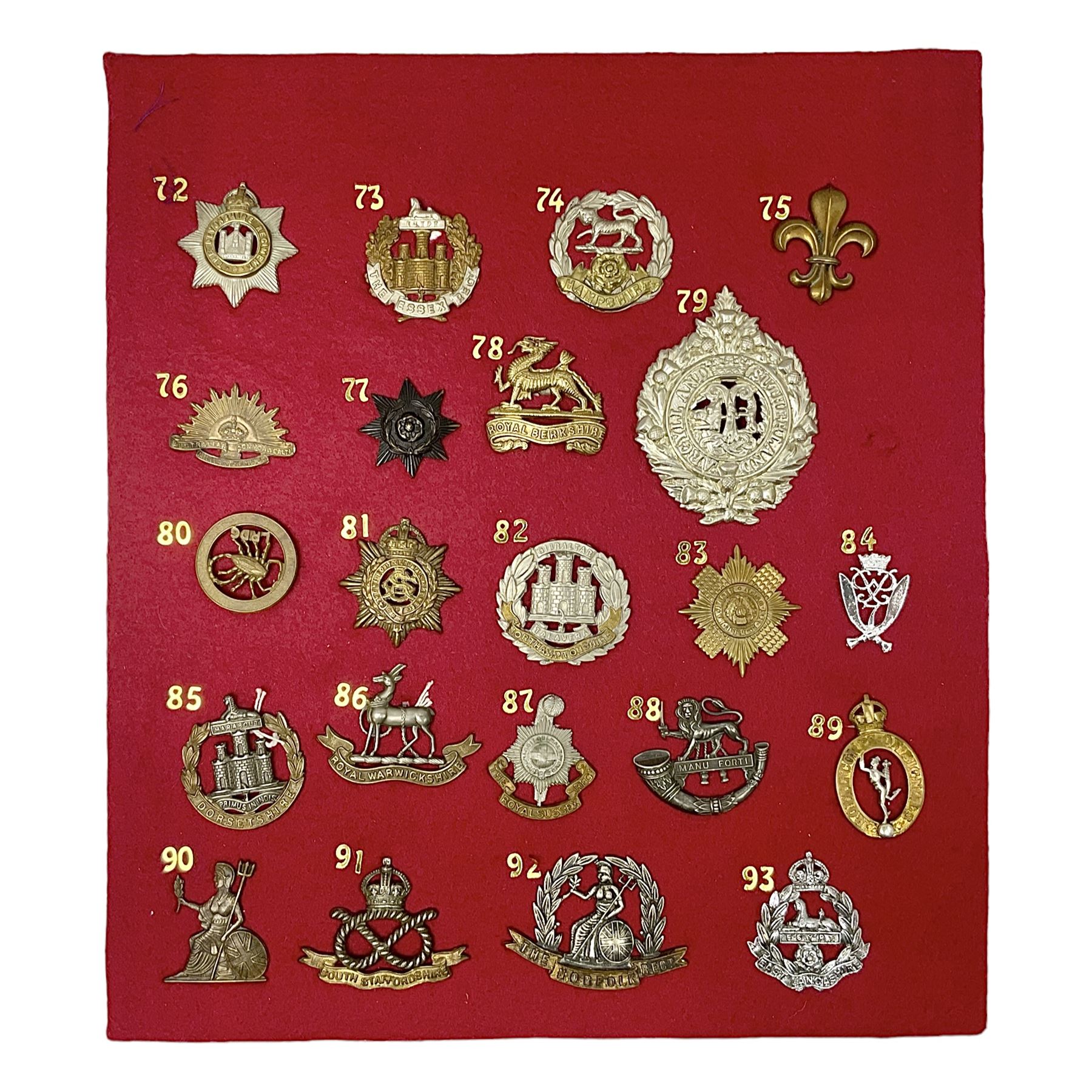 Twenty-two glengarry and cap badges including Argyll & Sutherland, Devonshire, Essex, Hampshire, Royal Berkshire, Northamptonshire, Long Range Desert Group, Royal Corps of Signals, Norfolk, Dorsetshire, East Lancashire etc; mounted on a board for display