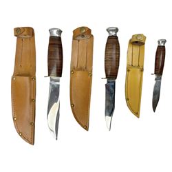 Graduated set of three Bowie knives by J. Nowill & Sons Sheffield England Est. AD1700, each with steel blade, brass cross-piece, stacked leather type grip and alloy pommel; largest blade 13cm and smallest 7.5cm; each in leather sheath (3)