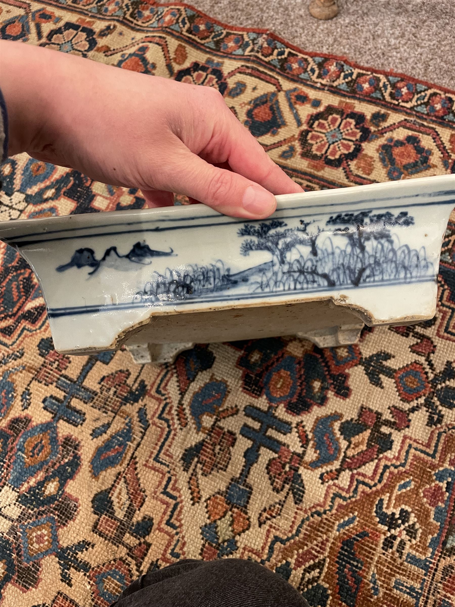 19th century Chinese blue and white planter and stand, each of square slightly tapering and flared form, the planter decorated with figures and precious objects between stylised foliate borders, the stand decorated with landscapes beneath a lipped rim with cell band, planter H28cm D25.5cm, stand H7cm D26cm