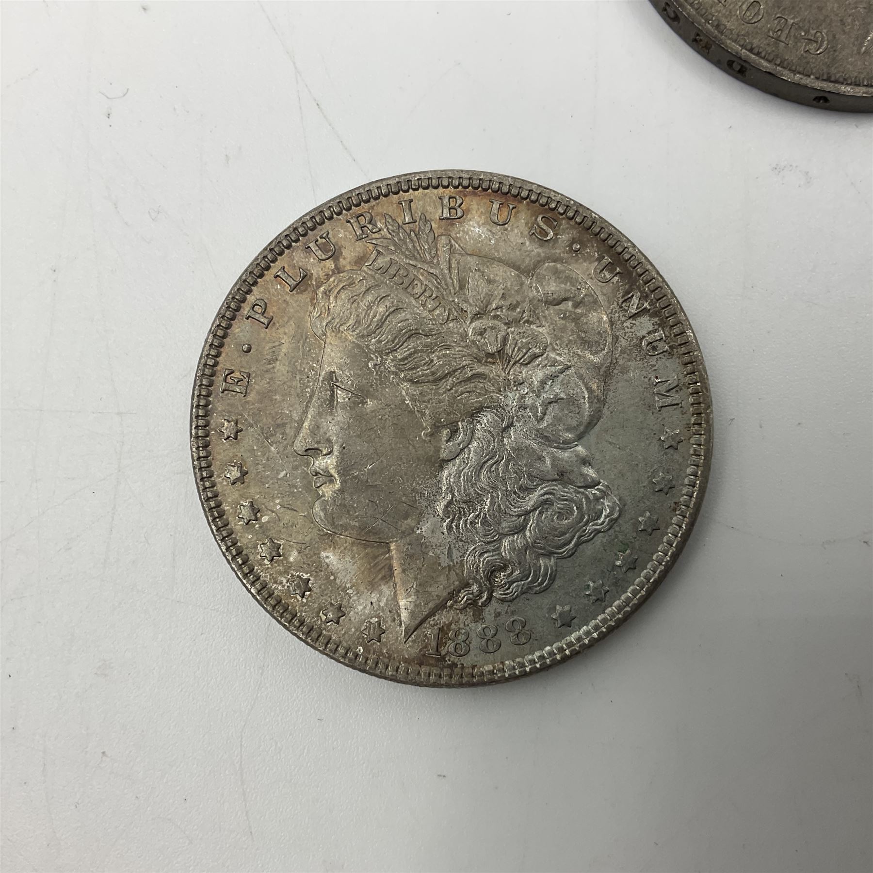 Two United States of America silver Morgan dollars dated 1885 O, 1888 O, King George V 1935 crown coin, and Mexico 1968 twenty-five pesos coin